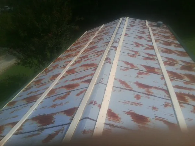 Rusted metal roof panels with new wood purlins before replacement — Storm Damage Roof Repair in Cherry Point by Roofing Brothers